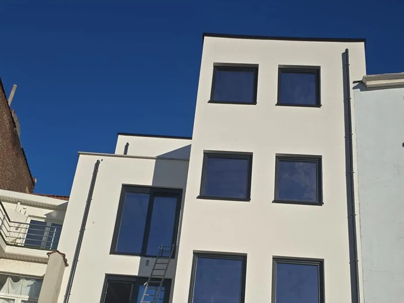 Casă cu tencuială albă renovată de ALSAI Façades